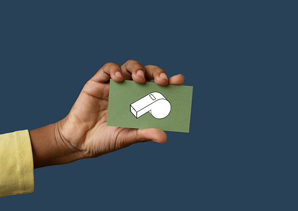 Hand mit einer Kärtchen, auf dem eine Trillerpfeife ist